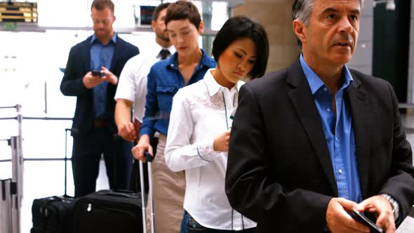 Commuters standing in queue for check-in