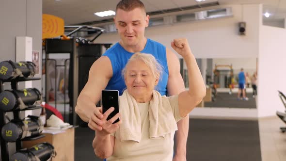 Portrait of a Young Coach in Uniform and an Old Woman in Gym