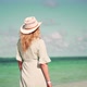 Woman Relaxing On Bahamas Flowing Dress Blowing In Wind.Travel Mood Wind Blows Dress On Ocean Resort - VideoHive Item for Sale