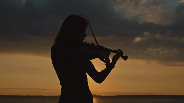 Silhouette of Young Lady Playing Violin