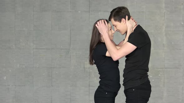 Young Beautiful Couple Dancing Together in Studio