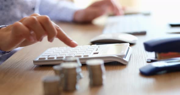 Business Person Presses Buttons of Computer Keyboard and Calculator in Analysis of Business and