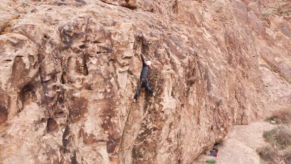 Man Athlette Climbing on the High Rock