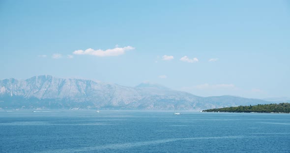 Sailing Yacht Boat in Open Blue Sea Near a Beautiful Ionian Island