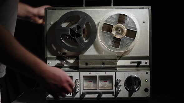 Man Puts Old Vintage Reel Player on Table and Turns It on