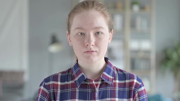 Close Up of Young Woman Looking At the Camera And Smiling