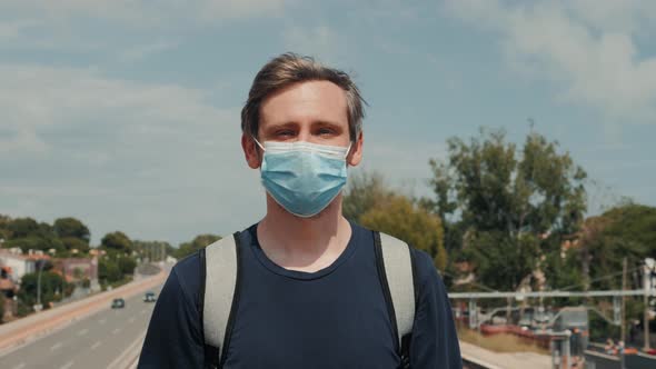 Young Man Guy in Medical Mask for Prevention of Coronavirus After Quarantine is Over Traveler with