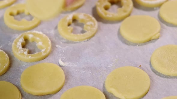 Woman Puts Round Piece of Dough on Parchment on Table