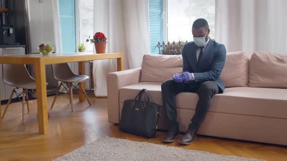 African Entrepreneur in Gloves and Mask Going Out for Work