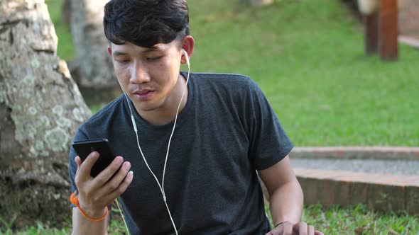 Man Listening To Music And Using Phone