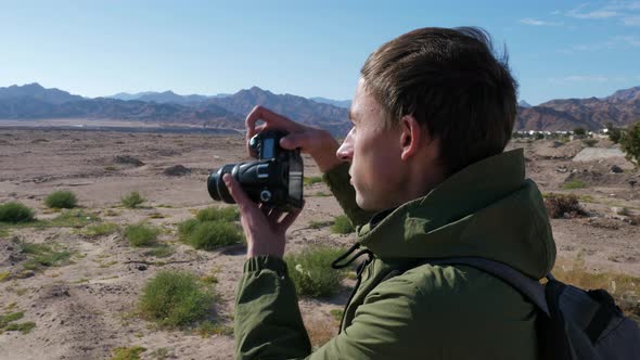 Photographer Takes Pictures of Mountain Landscape