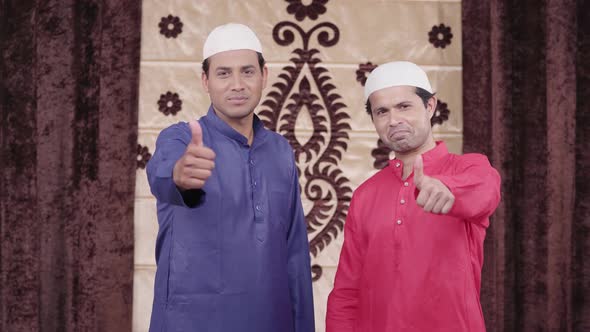 Two Muslim men showing thumbs up