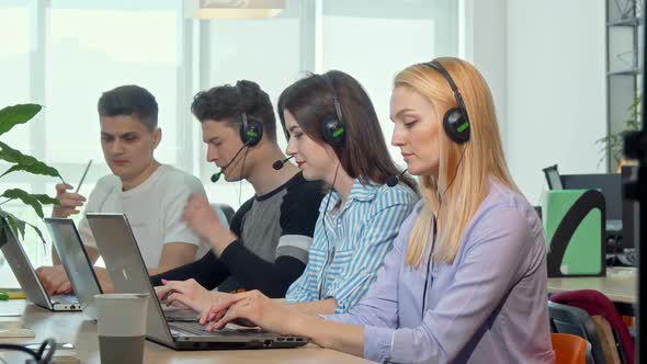 Beautiful Young Woman Answering Calls, Working at Customer Support Call Center