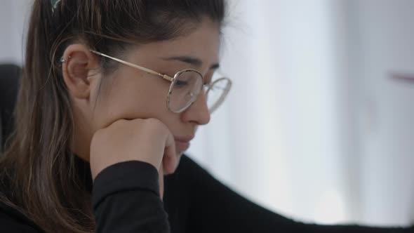 Close Up Shot of a Young Collage Girls Face Wearing Round Shape Glasses While Studying at Home