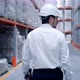 Follow footage of employees male warehouse worker engineer in hard hat working - VideoHive Item for Sale