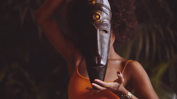 Beautiful Woman Holding And Posing With Traditional Mask