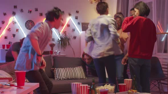 Group of Joyous Diverse Friends Dancing Together at Home Party