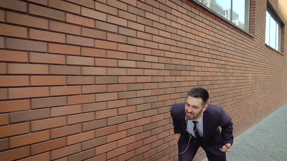 Happy Successful Businessman Dancing In Wireless Earphones