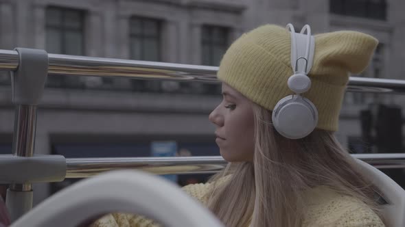 Blond Teenage Tourist With Headphones On Bus