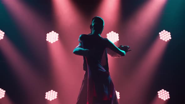 Graceful Argentine Tango Among Smoke and Bright Red Neon Lights in a Dark Studio