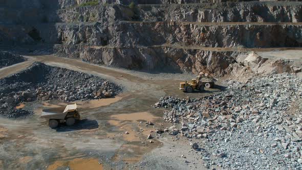 Large Vehicles Working Around a Large Open Quarry