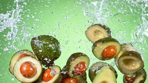 Super Slow Motion Shot of Flying Avocados and Water Side Splash at 1000 Fps