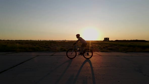 Silhouette of Mountain Biker at Sunset, Slow Motion