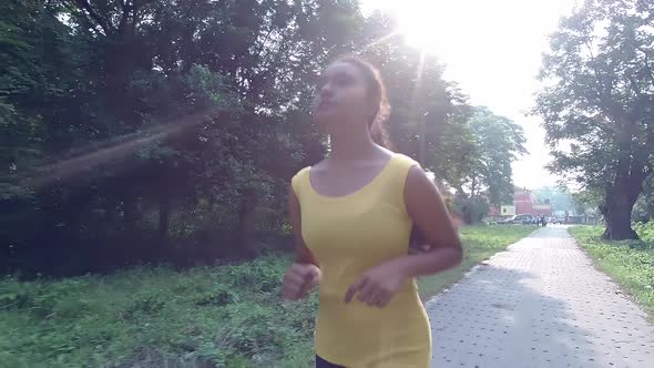 Young Asian girl running or jogging at morning or evening sunset or sunrise in nature