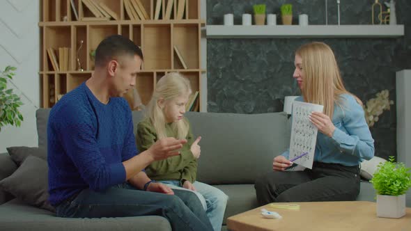 School Age Girl with Hearing Loss and Parents Learning English Sign Language