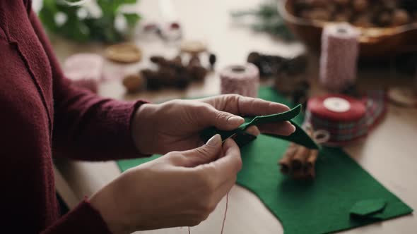 Close up of woman's hands preparing Christmas decoration. Shot with RED helium camera in 8K