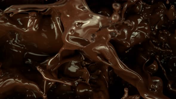 Super Slow Motion Shot of Splashing Melted Chocolate Background at 1000 Fps alt