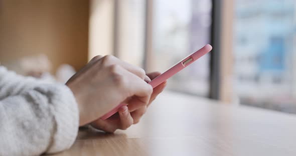 Woman use of mobile phone in coffee shop