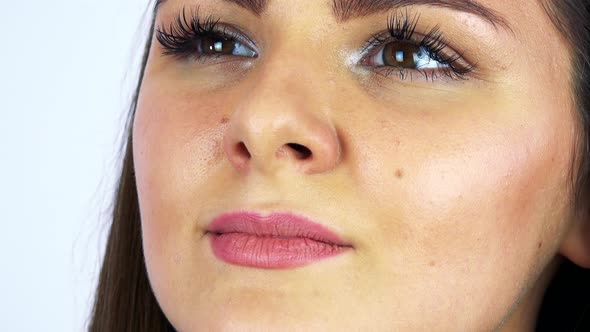 A Young Beautiful Woman Daydreams with a Smile - Face Closeup - White Background