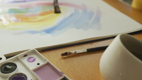 Close up of caucasian woman painting with watercolours at home