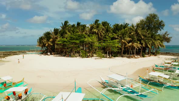 Tropical Guyam Island with a Sandy Beach and Tourists