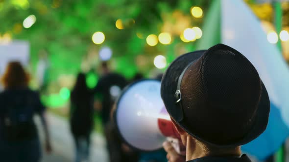 Megaphone Activist Speaks While Marching in Political Picketing Protesters Crowd