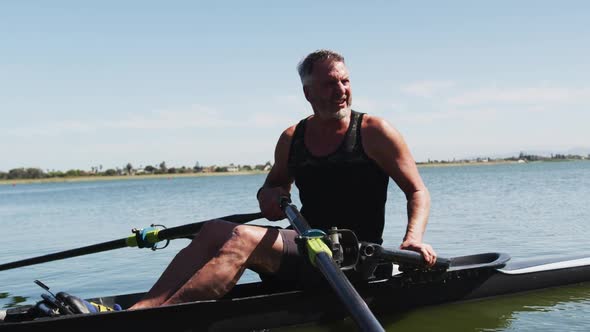 Senior caucasian man preparing rowing boat in a river