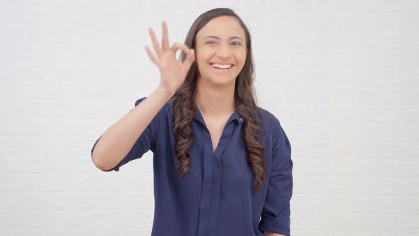 Indian girl showing Okay sign