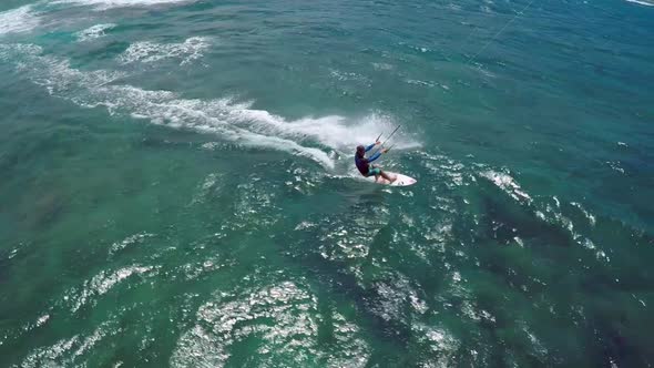 Aerial view of a man kitesurfing in Hawaii