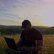 Man with laptop sitting and networking in the country - VideoHive Item for Sale
