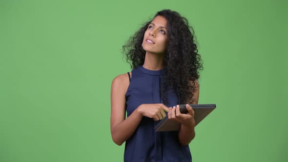 Young Beautiful Hispanic Businesswoman Using Digital Tablet