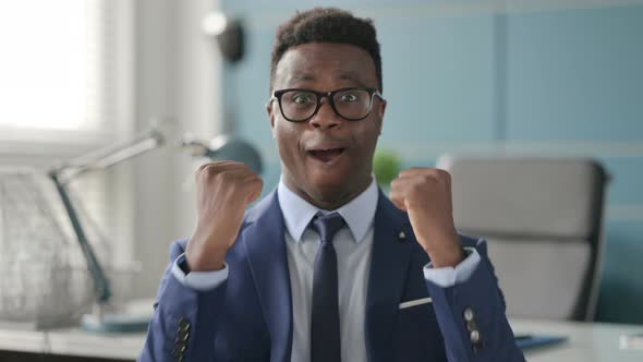 Portrait of Excited African Businessman Celebrating Success