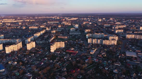 Flying Over City At Sunset