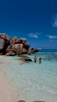 Anse Cocos La Digue Seychelles a Young Couple of Men and Women on a Tropical Beach During a Luxury