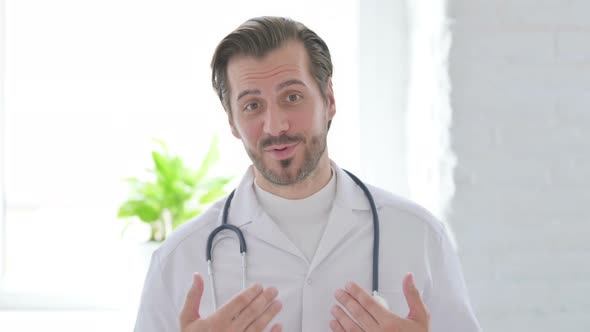 Portrait of Young Doctor Talking on Online Video Call