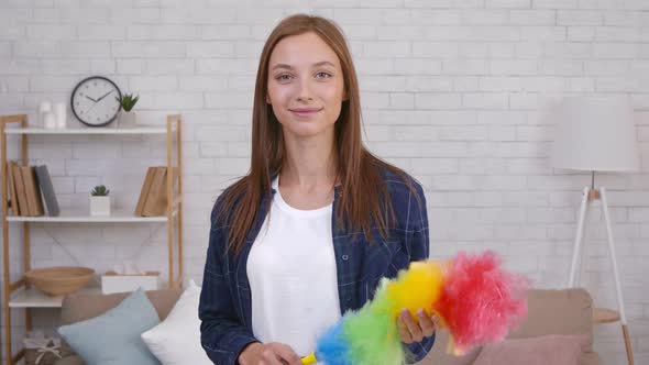 Indoors Portrait of Cute Woman Holding Cleaning Sweep Looking at Camera Slow Motion