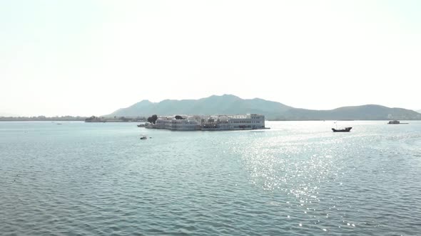 Majestic white Taj Lake Palace resting above the surface of lake Pichola in Udaipur, India