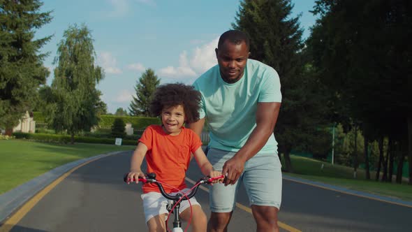 Cute Mixed Race Boy Learning Cycling Outdoors