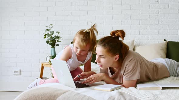 Mother Working From Home Having a Work Video Call While Her Child Distracts and Drawing Attention