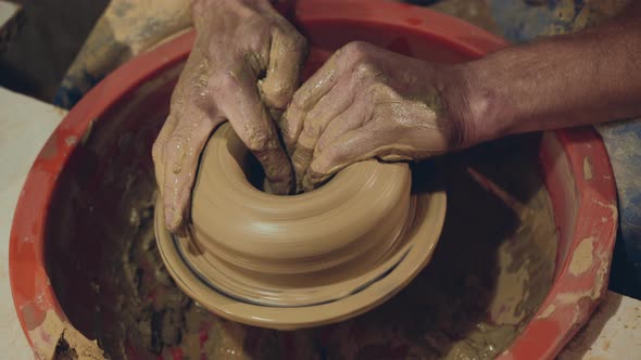 Top View of Manly Male Hands Making Clay Bowl, Using Wheel in Workshop